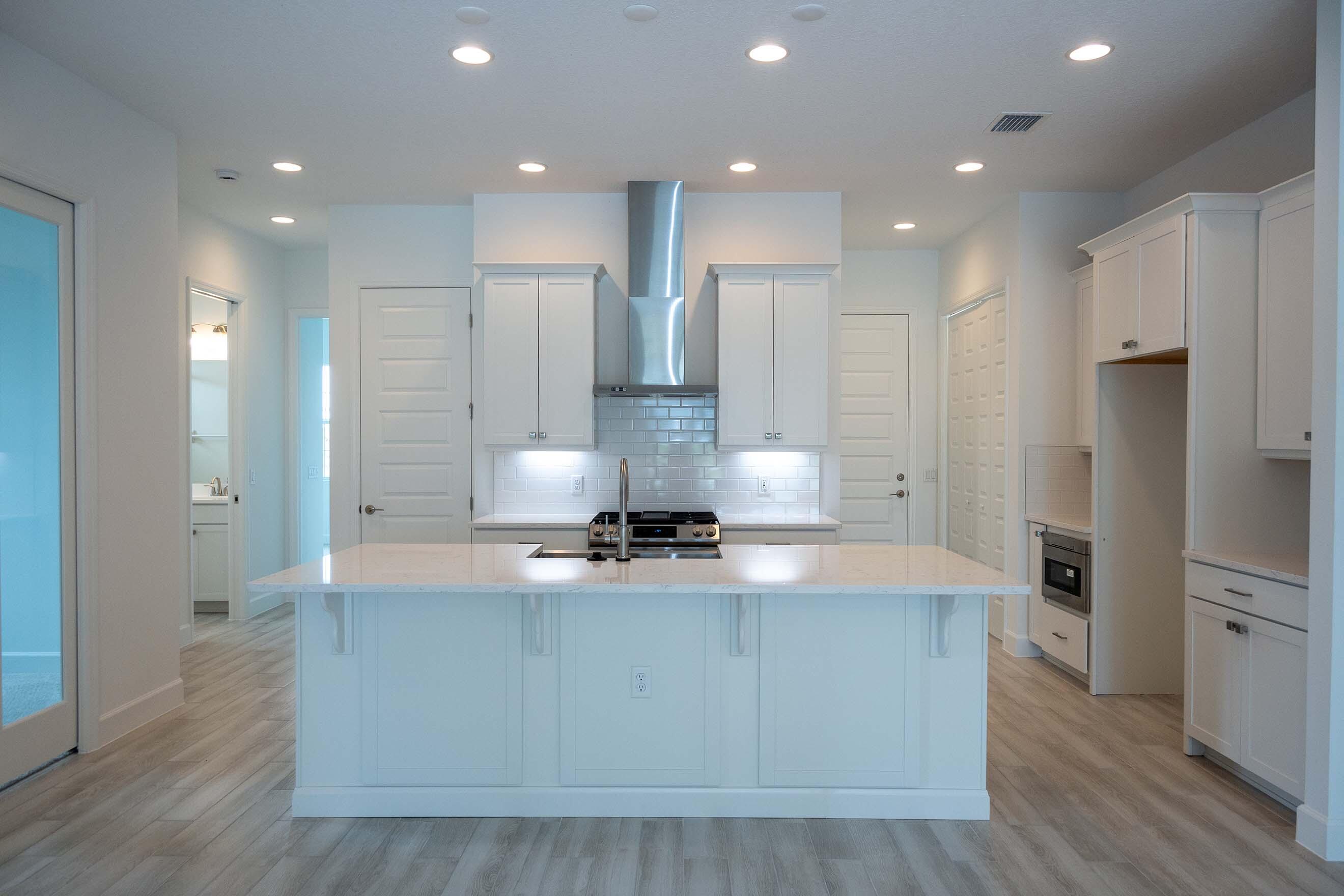7809 Cache Crk Lane Melbourne, FL 32940 - Photo 3 of 35 a large kitchen with stainless steel appliances granite countertop a large counter top a refrigerator and a stove