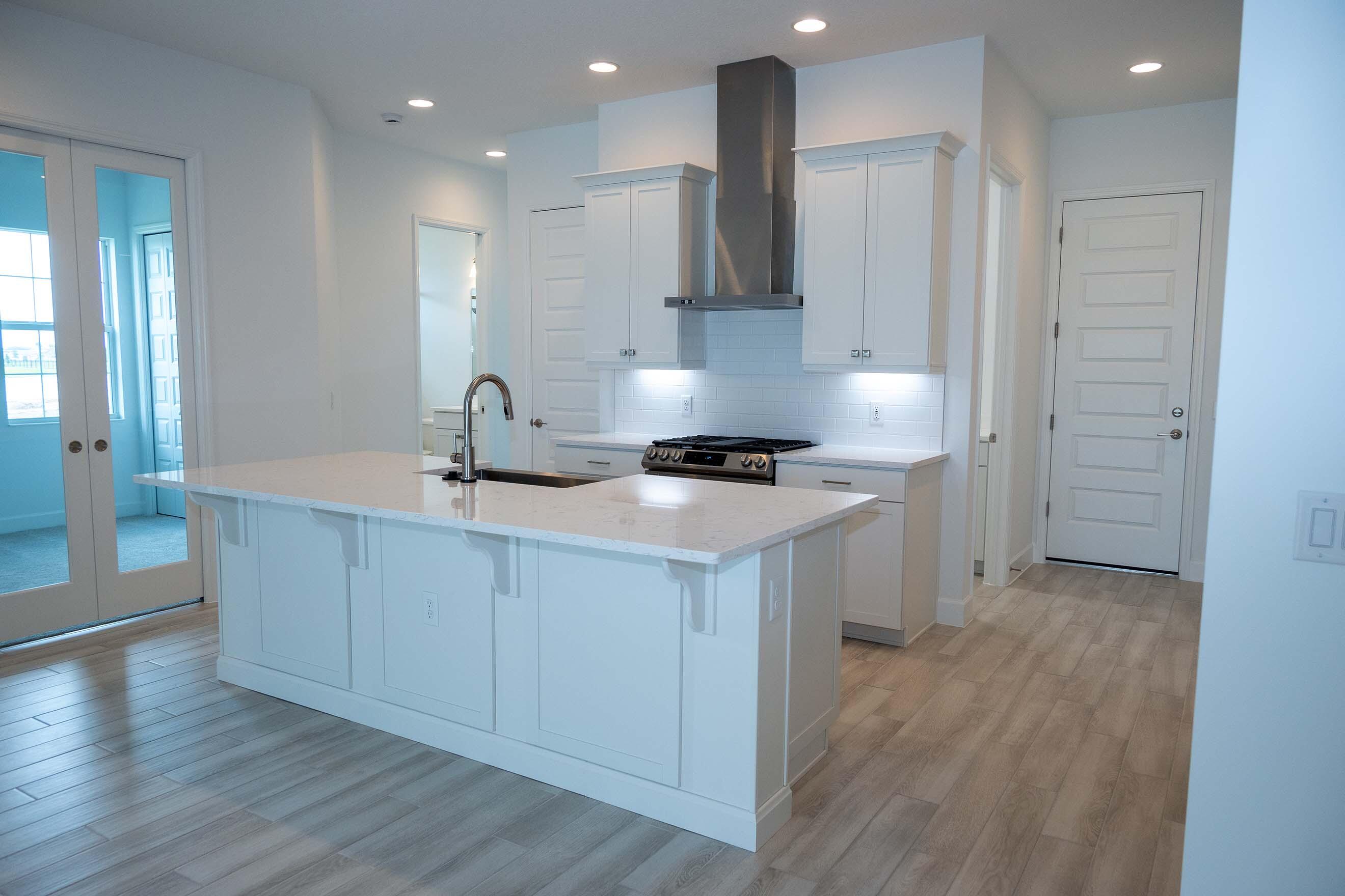7809 Cache Crk Lane Melbourne, FL 32940 - Photo 4 of 35 a kitchen with a sink cabinets and wooden floor