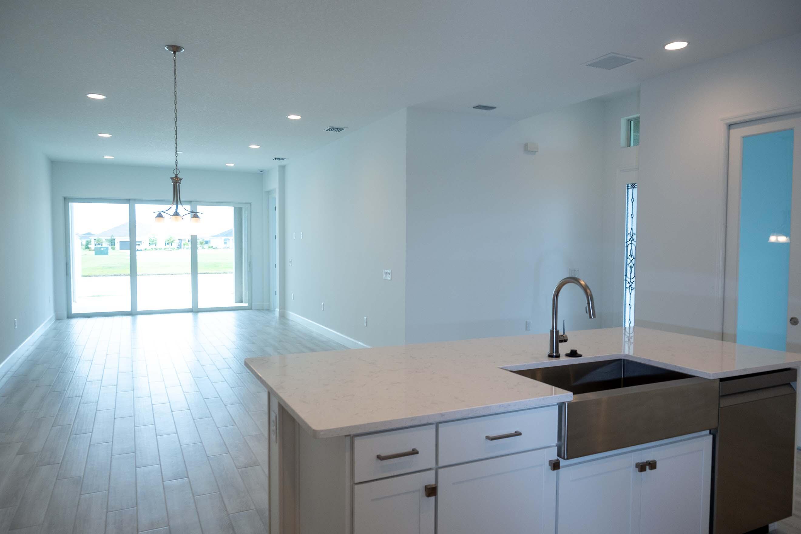 7809 Cache Crk Lane Melbourne, FL 32940 - Photo 34 of 35 a kitchen with a sink a counter space and a window