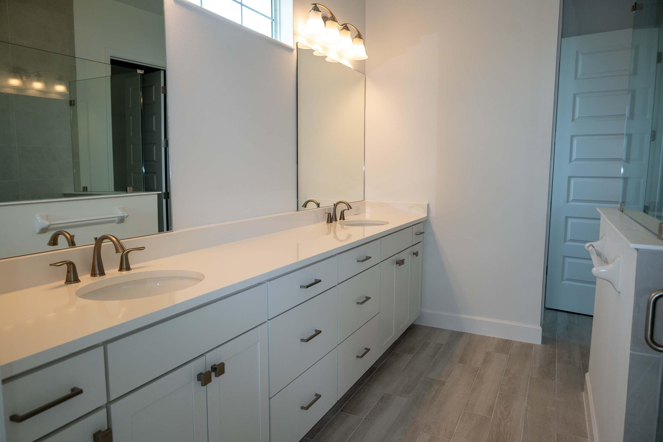 7809 Cache Crk Lane Melbourne, FL 32940 - Photo 9 of 35 a bathroom with a double vanity sink and a mirror