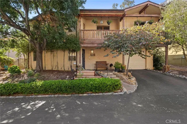 a front view of a house with a garden