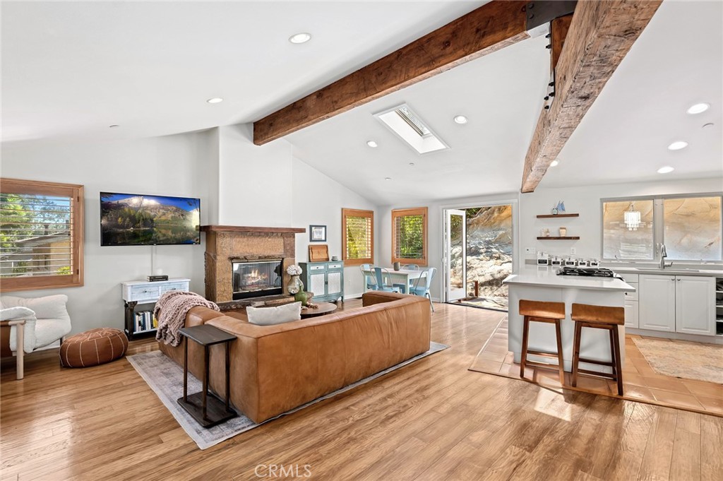 2072 Hidden Valley Canyon Road Laguna Beach, CA 92651 - Photo 5 of 26 a living room with fireplace furniture and a flat screen tv