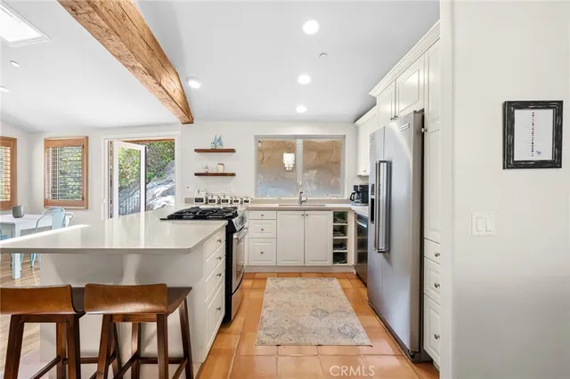a kitchen with refrigerator cabinets and large window