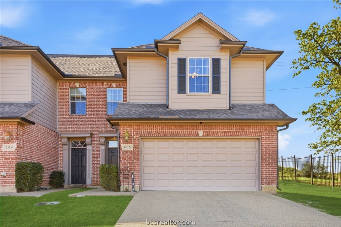 1425 West Villa Maria Road, Unit 605 Bryan, TX 77801 - Photo 1 of 46 View of front of house featuring driveway, brick siding, and an attached garage