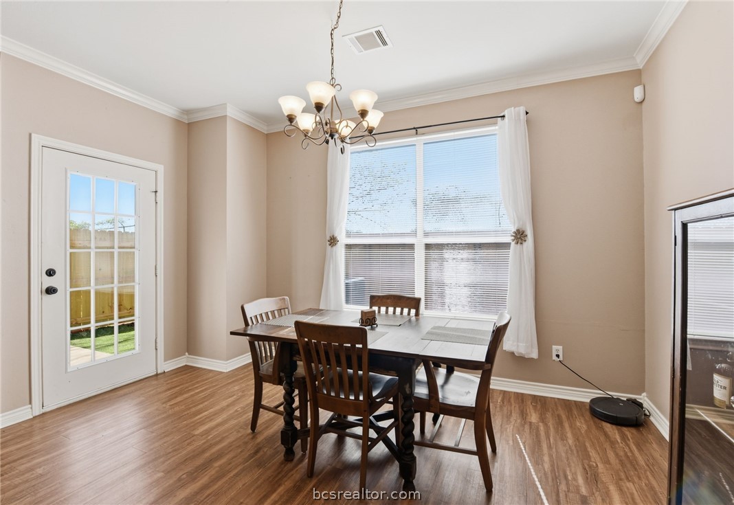 1425 West Villa Maria Road, Unit 605 Bryan, TX 77801 - Photo 16 of 46 Dining room featuring hanging lights, ornamental molding, and wood finished floors