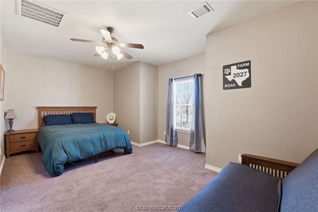 1425 West Villa Maria Road, Unit 605 Bryan, TX 77801 - Photo 24 of 46 Bedroom with light colored carpet and ceiling fan