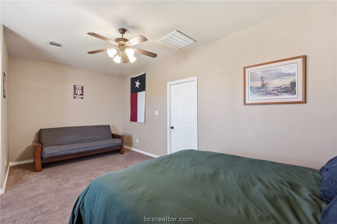 1425 West Villa Maria Road, Unit 605 Bryan, TX 77801 - Photo 25 of 46 Carpeted bedroom featuring baseboards and a ceiling fan