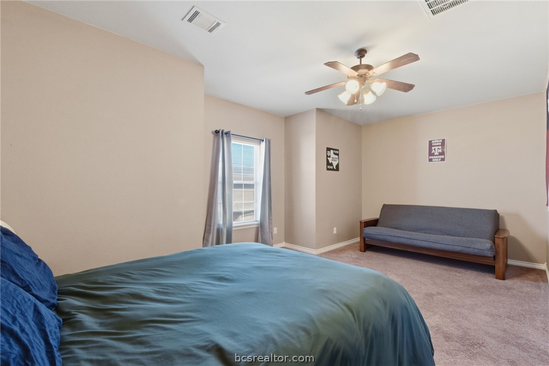 1425 West Villa Maria Road, Unit 605 Bryan, TX 77801 - Photo 26 of 46 Bedroom featuring light carpet and a ceiling fan
