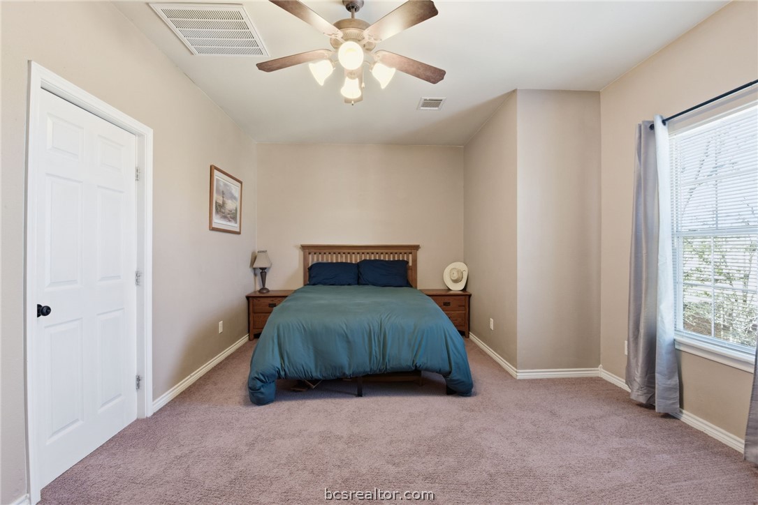 1425 West Villa Maria Road, Unit 605 Bryan, TX 77801 - Photo 27 of 46 Carpeted bedroom featuring baseboards and a ceiling fan