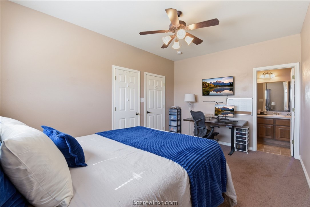 1425 West Villa Maria Road, Unit 605 Bryan, TX 77801 - Photo 38 of 46 Bedroom featuring carpet floors, ensuite bathroom, ceiling fan, and a desk