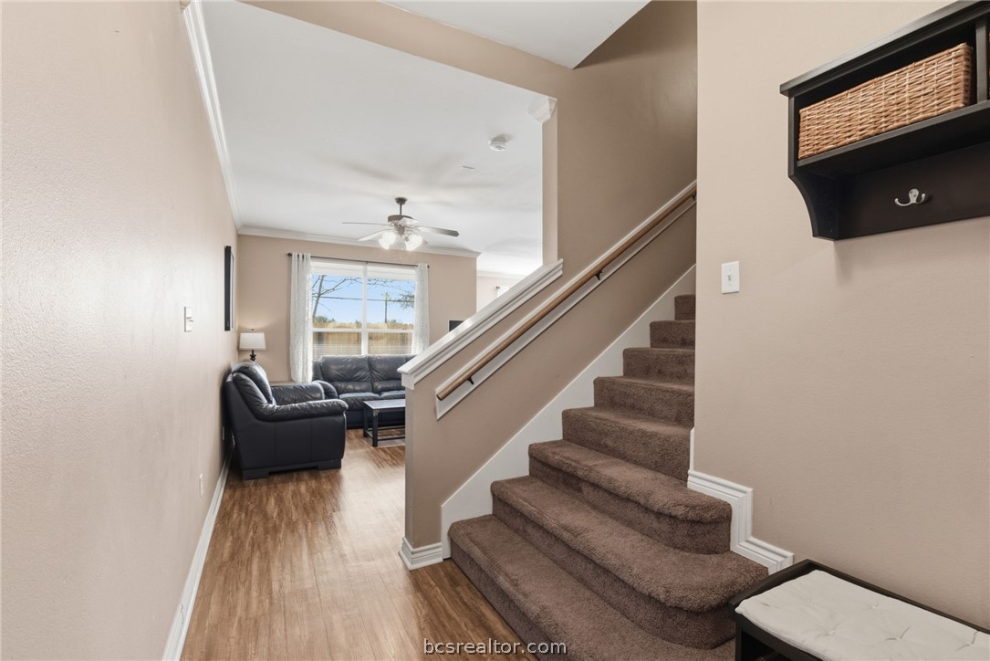 1425 West Villa Maria Road, Unit 605 Bryan, TX 77801 - Photo 6 of 46 Stairs featuring wood finished floors, a ceiling fan, and crown molding