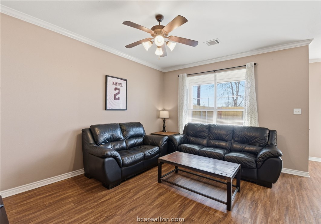 1425 West Villa Maria Road, Unit 605 Bryan, TX 77801 - Photo 9 of 46 Living room with ornamental molding, wood finished floors, and ceiling fan