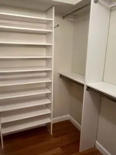 a view of walk in closet with empty racks