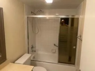 a bathroom with a bathtub and shower
