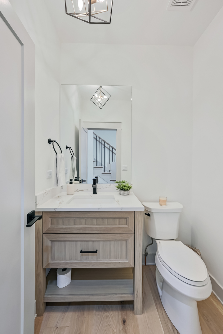 1205 Ridge Road Westmont, IL 60527 - Photo 10 of 25 a bathroom with a sink a toilet and mirror