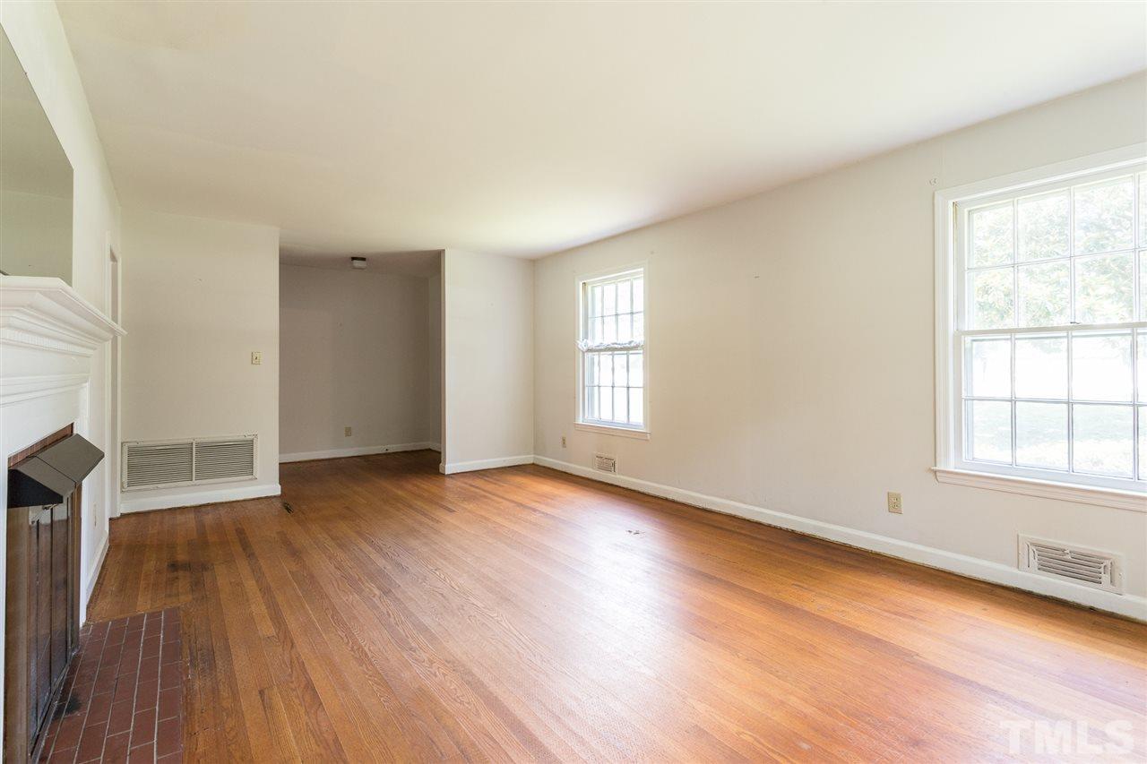 4929 Kaplan Drive Raleigh, NC 27606 - Photo 14 of 30 an empty room with wooden floor and windows