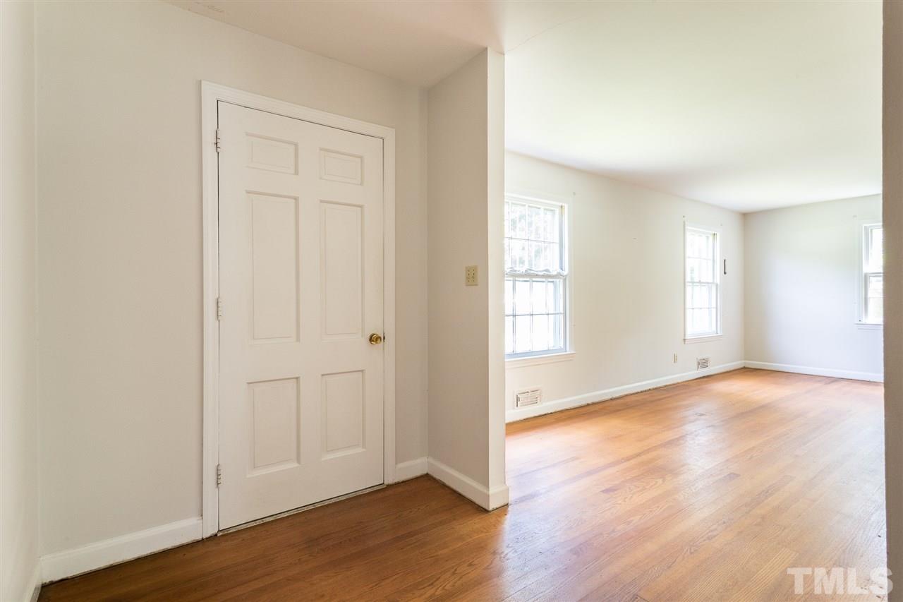 4929 Kaplan Drive Raleigh, NC 27606 - Photo 9 of 30 an empty room with wooden floor and windows