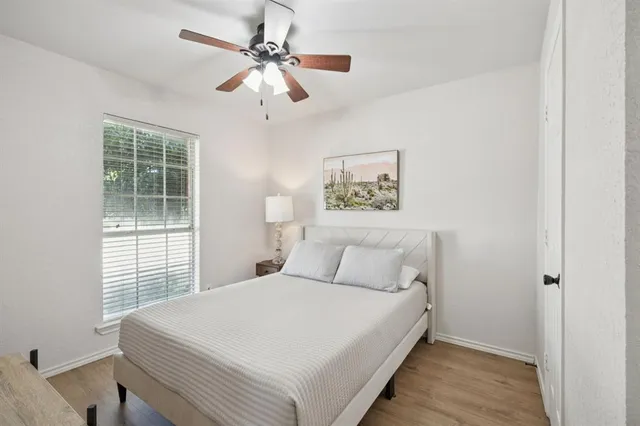 a bedroom with a large bed and a chandelier