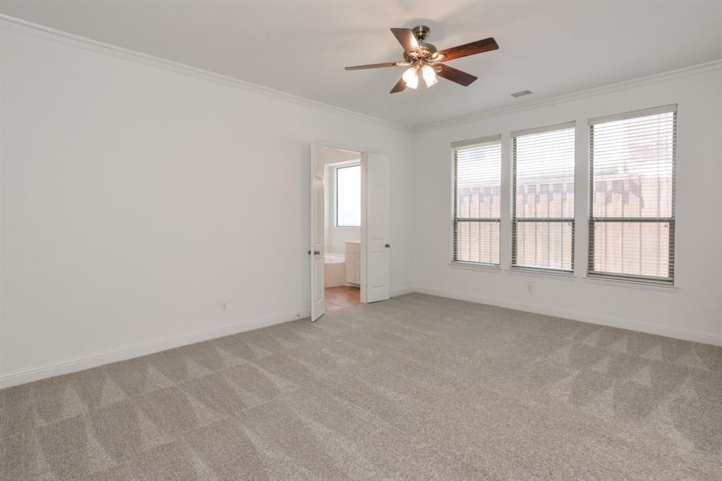 11007 Southwyck Drive Frisco, TX 75033 - Photo 14 of 36 an empty room with chandelier fan and windows