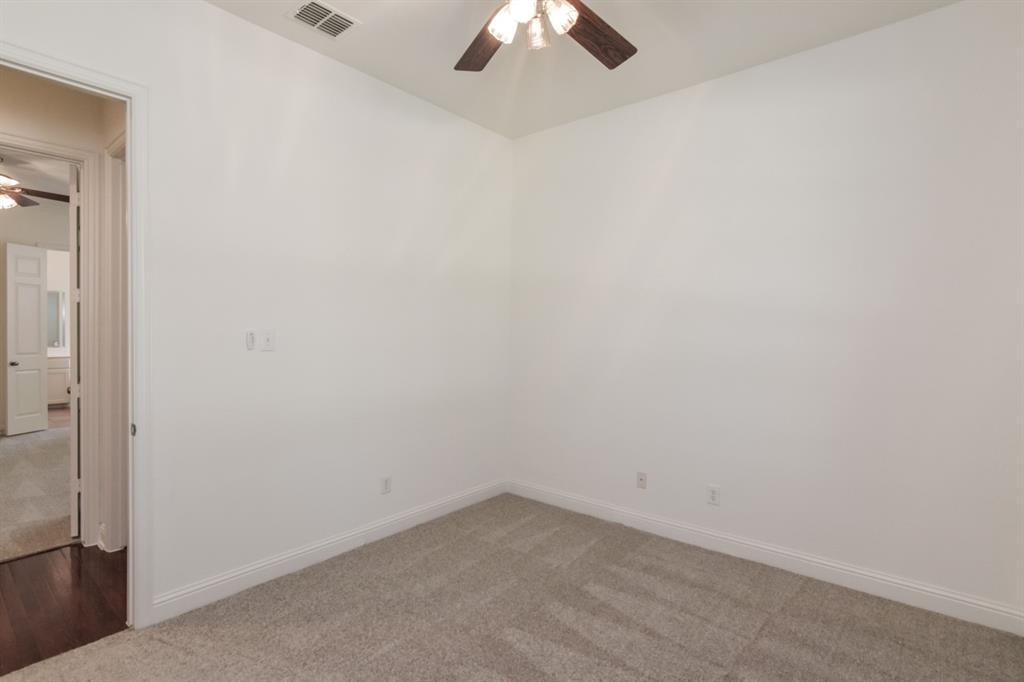11007 Southwyck Drive Frisco, TX 75033 - Photo 24 of 36 an empty room with a chandelier fan