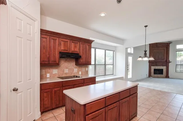 a kitchen with a sink cabinets and window