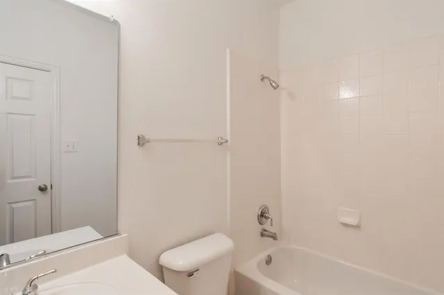 a bathroom with a toilet and a bathtub
