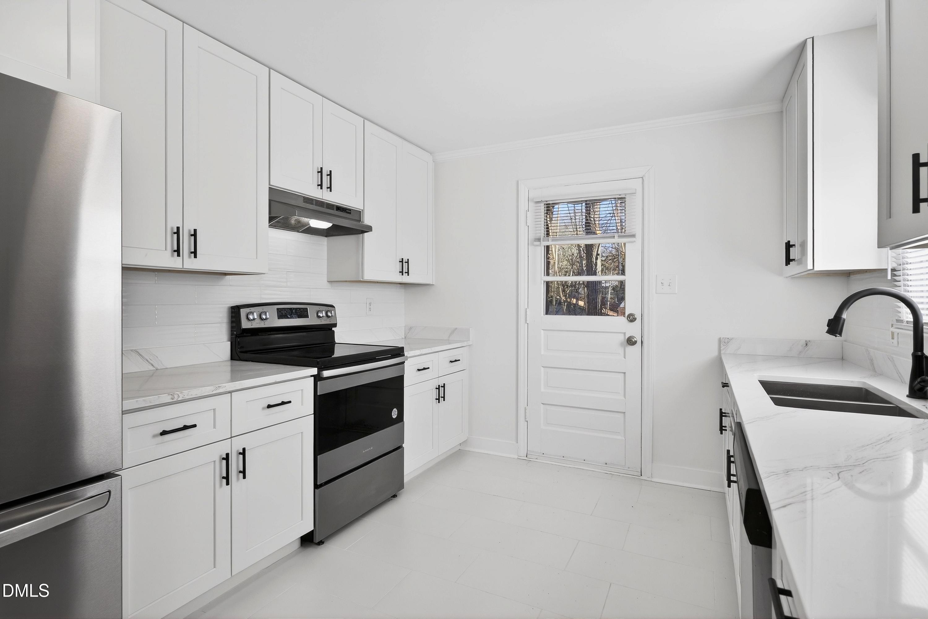 302 Normandy Street Durham, NC 27707 - Photo 9 of 29 a kitchen with white cabinets and white appliances