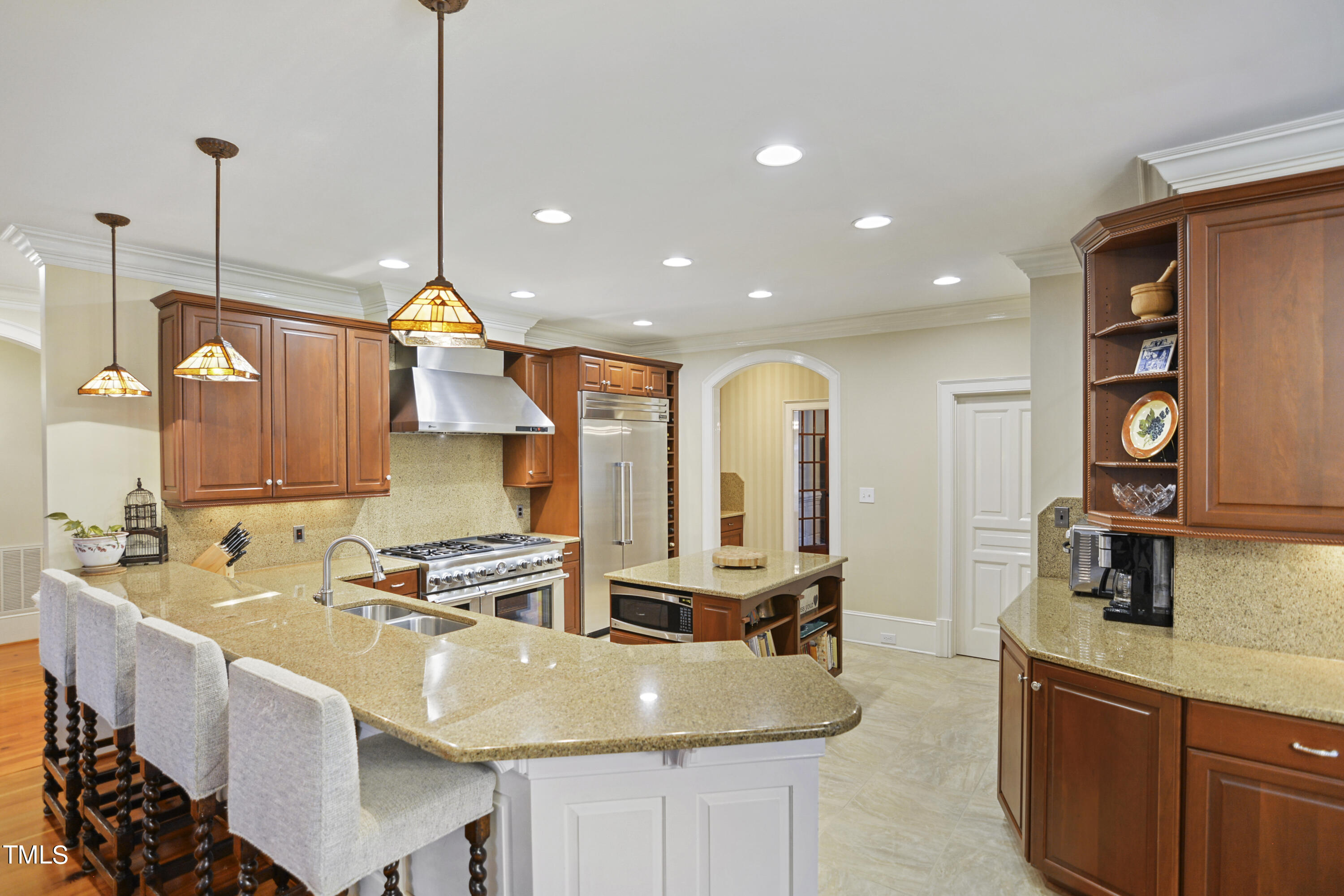 11004 Brass Kettle Road Raleigh, NC 27614 - Photo 13 of 57 a kitchen with stainless steel appliances granite countertop a sink a stove and a wooden floors