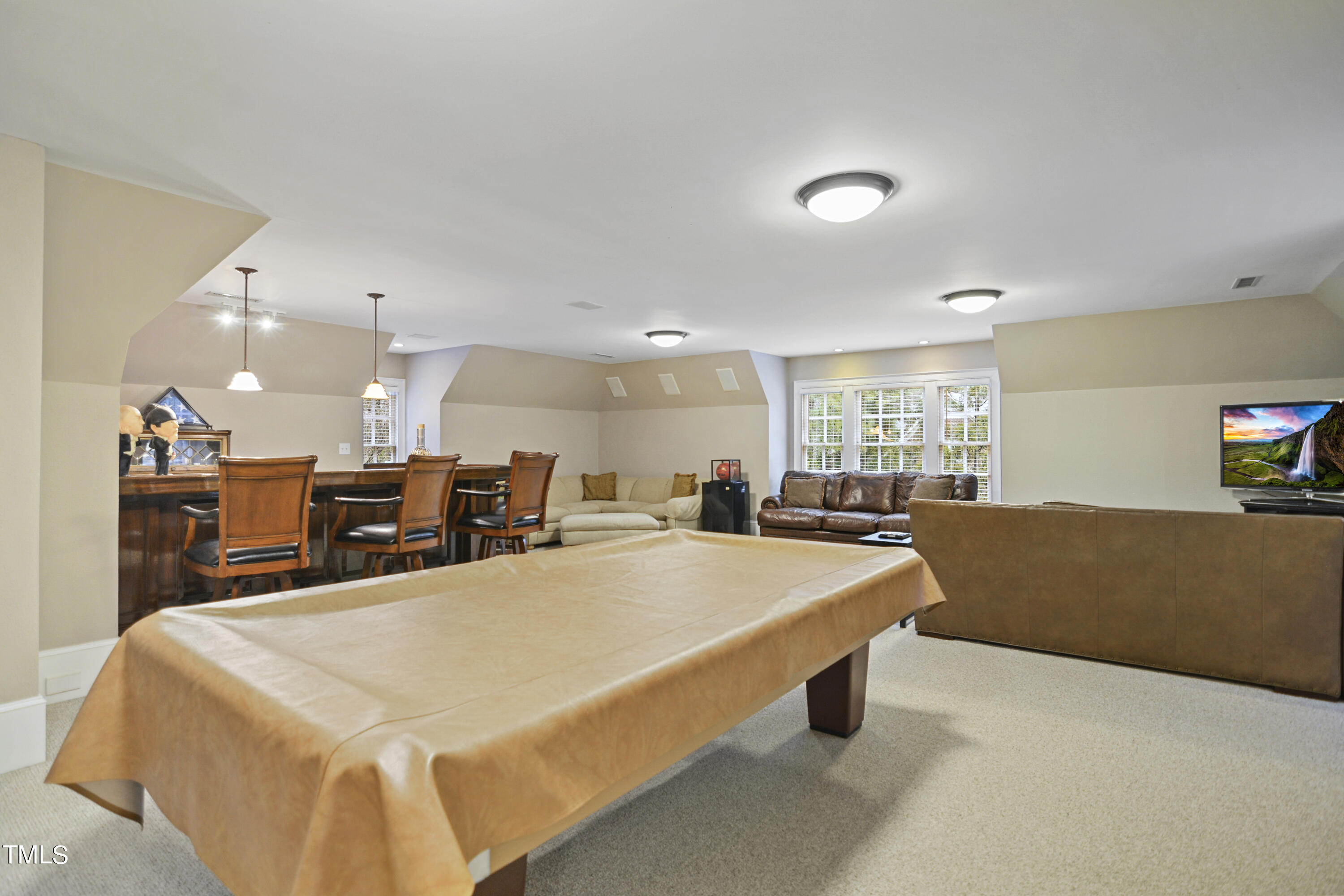11004 Brass Kettle Road Raleigh, NC 27614 - Photo 36 of 57 a living room with kitchen island a table and chairs in it