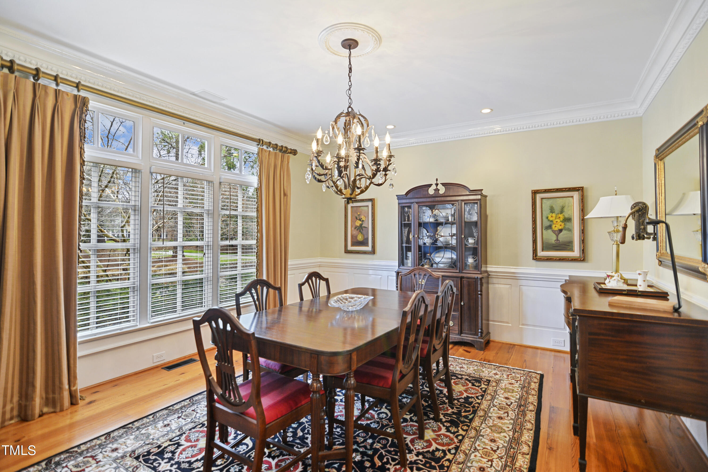 11004 Brass Kettle Road Raleigh, NC 27614 - Photo 9 of 57 a view of a dining room with furniture a chandelier and wooden floor