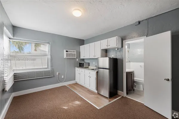 a kitchen with stainless steel appliances a refrigerator sink and cabinets