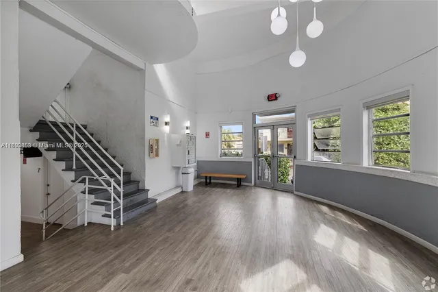 a view of an entryway with wooden floor