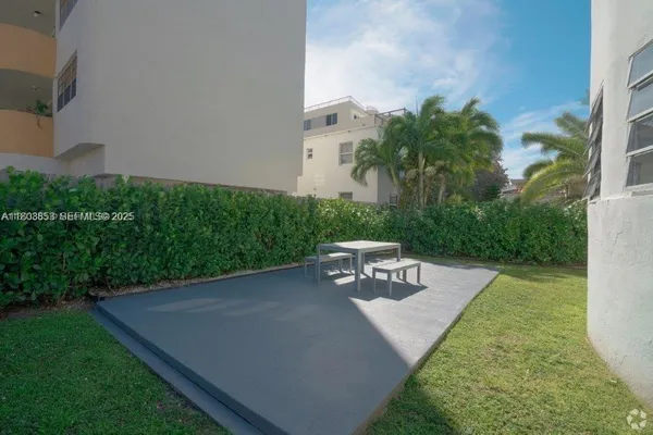 a view of a backyard with sitting area