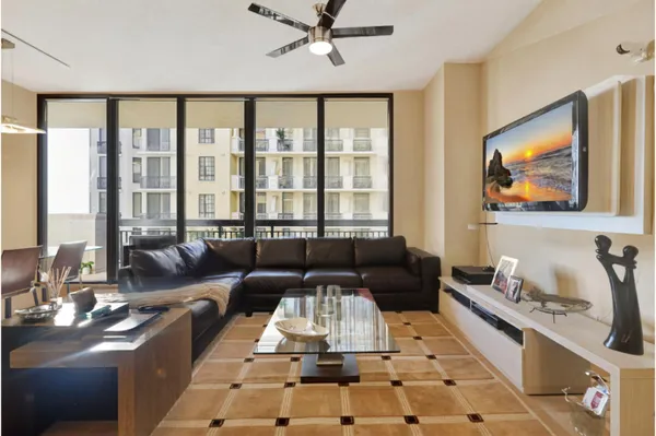 a living room with furniture and a floor to ceiling window