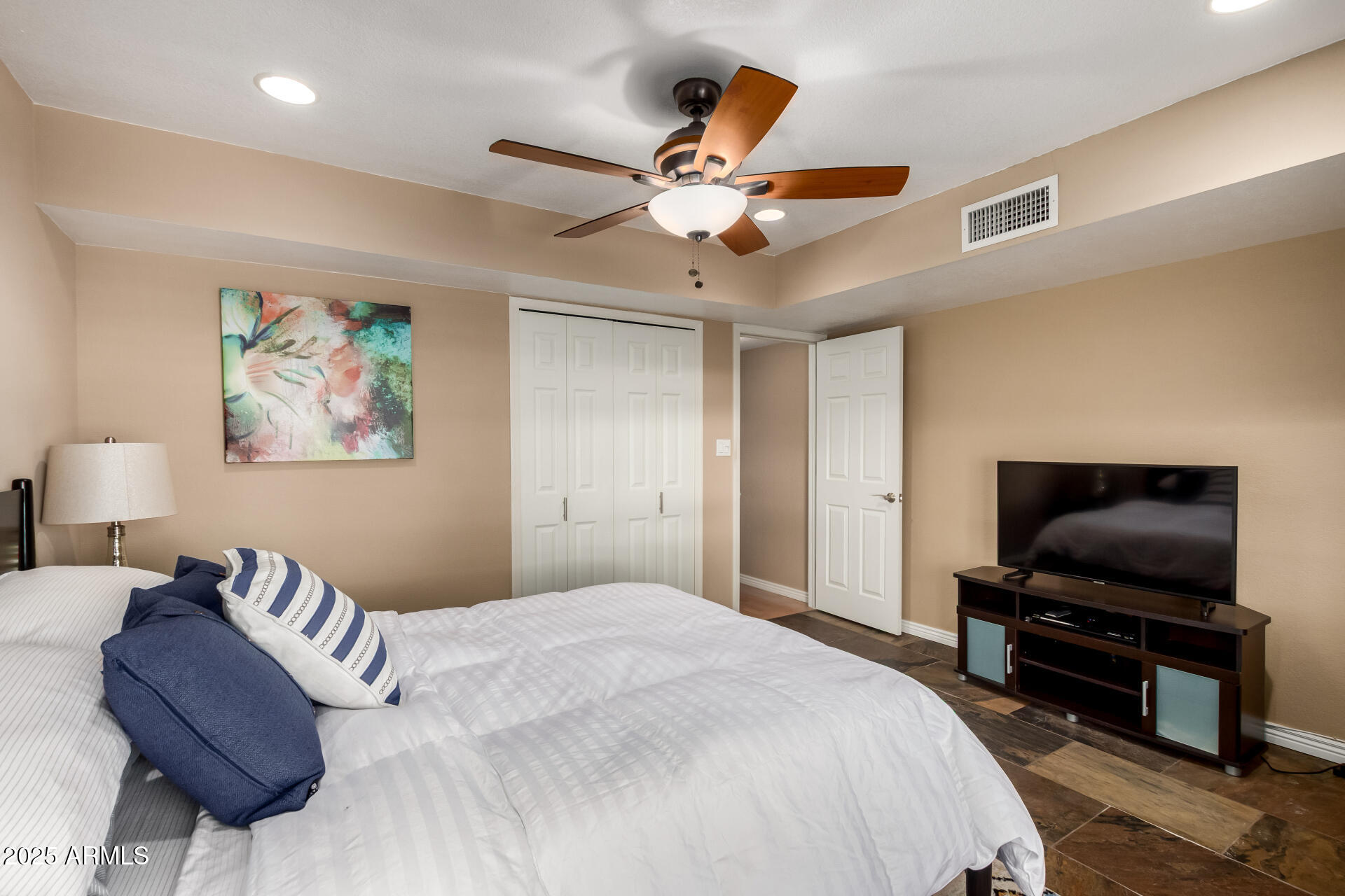 5319 North 15th Street Phoenix, AZ 85014 - Photo 14 of 30 a bedroom with a large bed and a flat screen tv