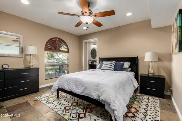 a bedroom with a large bed and a flat screen tv