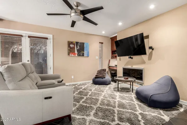 a living room with fireplace furniture and a flat screen tv