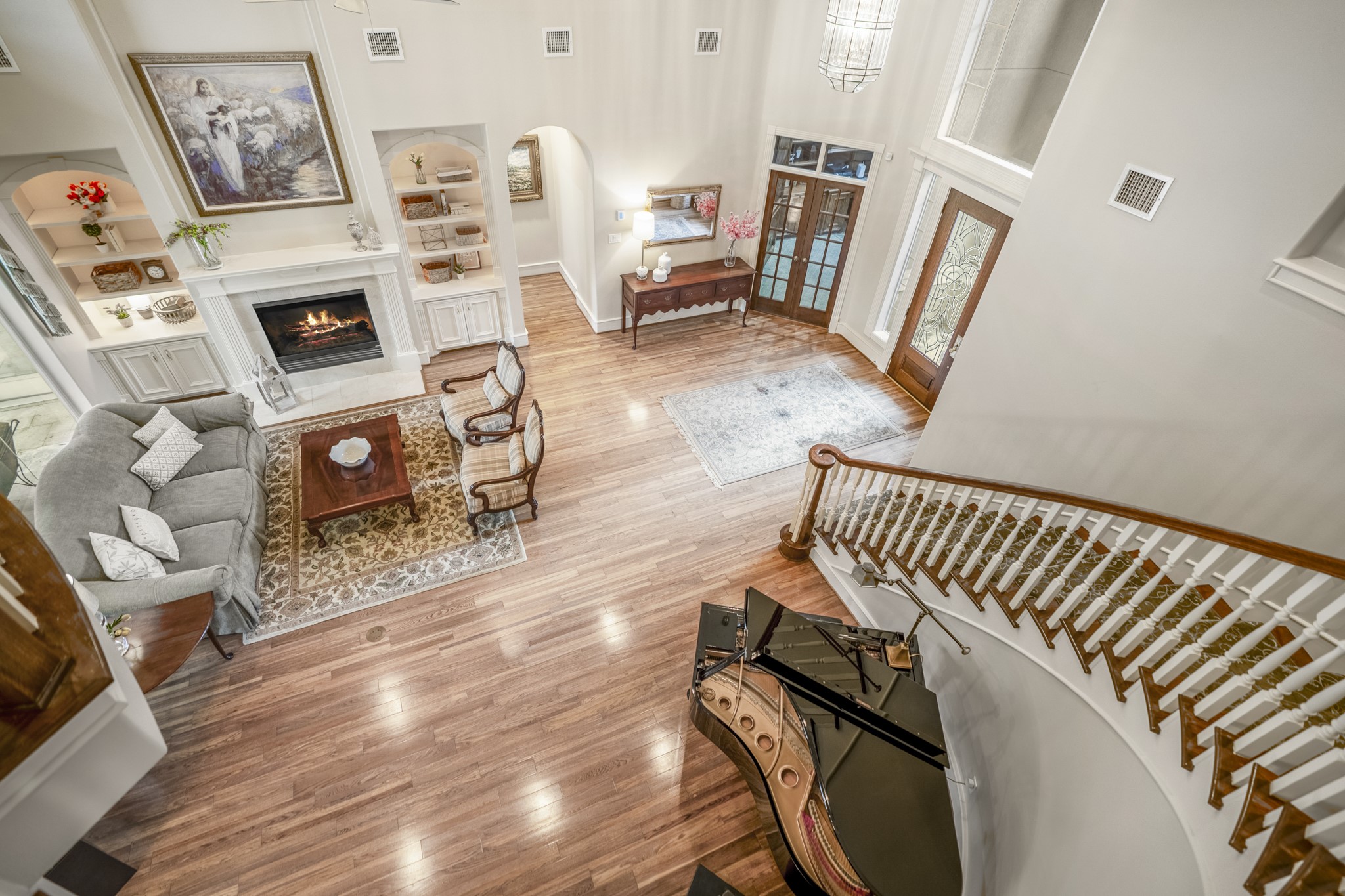 8806 Sterling Gate Circle Spring, TX 77379 - Photo 24 of 40 This is a view of the living room and foyer taken from the second floor. The lighted shelves and wood floors make this room stunning.