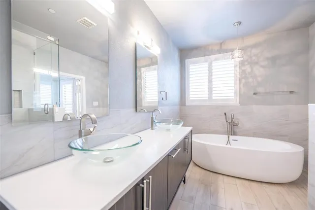 a bathroom with a double vanity sink window and a mirror