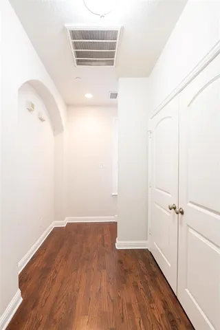 a view of a room with wooden floor