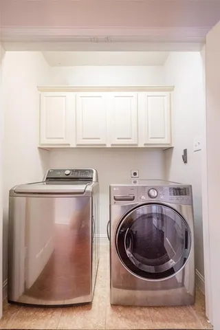a utility room with washing machine and racks