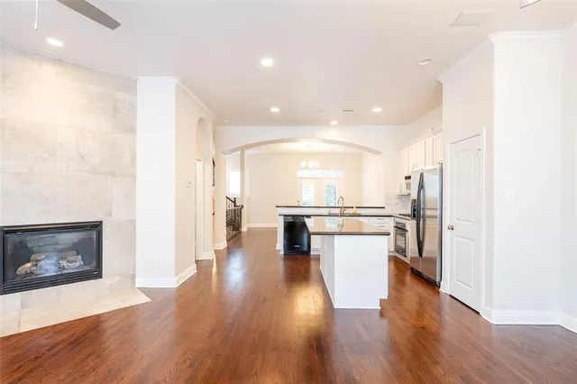 a view of a kitchen with a sink and a refrigerator