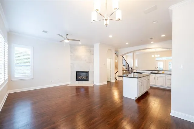 an open kitchen with white cabinets furniture and a fireplace