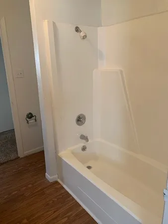 a bathroom with a granite countertop sink and white cabinets