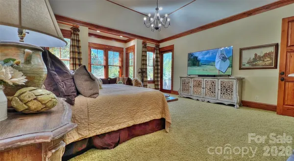 a bedroom with furniture and large windows