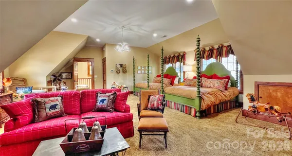 a spacious bedroom with a bed and a flat screen tv