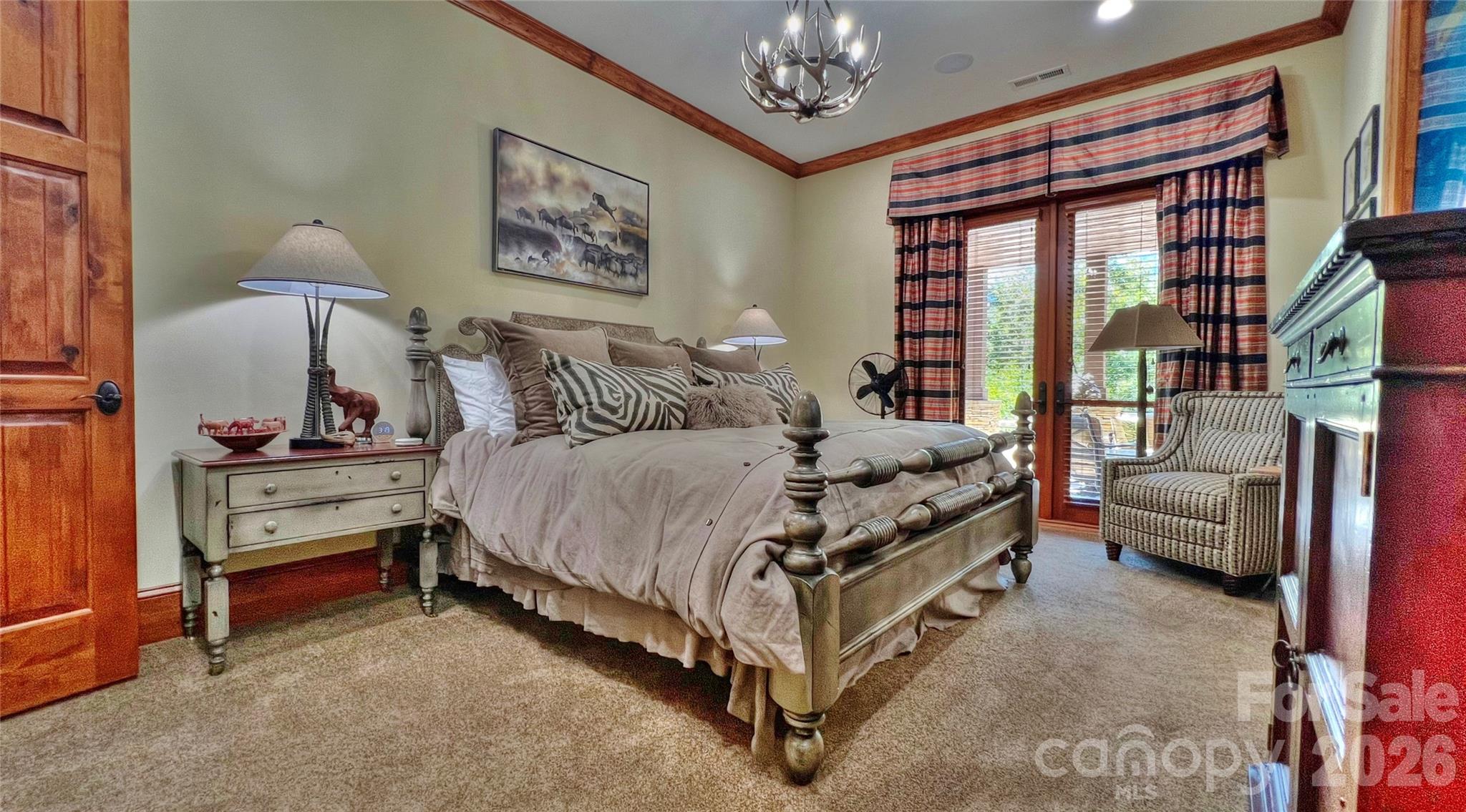 538 Chestertown Drive Mill Spring, NC 28756 - Photo 20 of 48 a spacious bedroom with a bed and a chandelier
