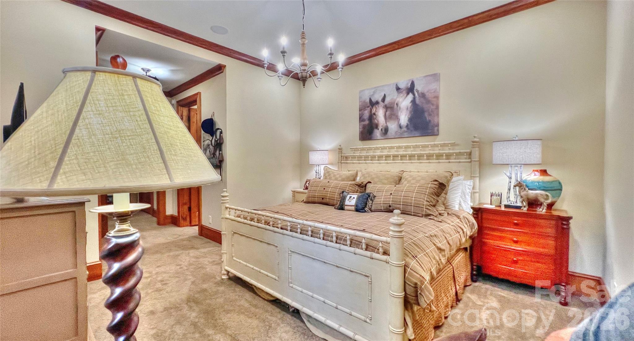 538 Chestertown Drive Mill Spring, NC 28756 - Photo 23 of 48 a bedroom with a bed and a chandelier