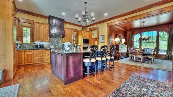 a kitchen with stainless steel appliances granite countertop a stove and cabinets