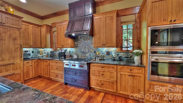 a dining room with furniture a rug and a chandelier